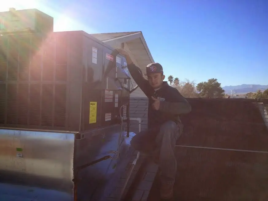 HVAC technician performing HVAC Inspection on a rooftop unit in Wanaque